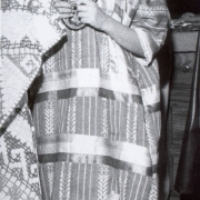 Ilse Velásquez, a young girl, poses in a traditional Mexican regional costume at the celebration of Our Lady of Guadalupe at Holy Family Church in Fort Collins (Larimer County), Colorado. She wears a hand woven dress decorated with ribbon, a bead necklace and has ribbons woven into her hair.