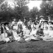 Group portrait of men and women with picnic baskets in Denver, Colorado.
