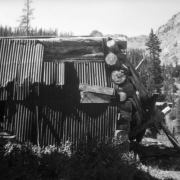 A dilapidated log and sheet metal shack stands on the verge of collapse at the Montezuma Mine, Pitkin County, Colorado.