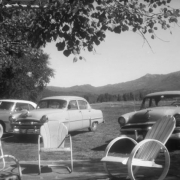 View of automobiles and metal patio chairs in Steamboat Springs, Routt County, Colorado.
