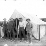 Outdoor portrait of a group of construction workers, they stand near a tent at the Alameda underpass construction site, Denver, Colorado.
