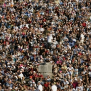 (OLYMPIA, GREECE, AUGUST 18, 2004) Fans sit along the grass banks of the Ancient Stadium in Olympia surrounding a remanding pillar as they watch Olympians pefrom in the shot put competition in the 2004 Athens Summer Olympic Games held in Olympia, Greec...