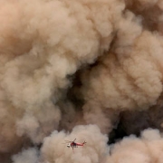 Smoke clouds dwarf a helicopter above the raging  Missionary Ridge Fire near Durango.