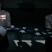 Jon Mueller and Matthew Baumann practiced folding a flag in preparation for the funeral of their friend.