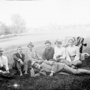 Outdoor portrait of a group of men and women in City Park, Denver, Colorado. The pavilion is in the distance.