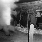 Members of the AdAmAn Club stand back as fireworks blast from a pipe tube, outside the Cog Railway Terminal building, Pikes Peak, Colorado Springs, El Paso County, Colorado.