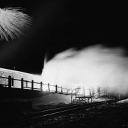 Silhouettes of members of the AdAmAn Club show in the illumination of fireworks on top of Pikes Peak, Colorado Springs, El Paso County, Colorado. Annual club festivities include a trek to the top of the 14,110 foot mountain to set off fireworks on New Years Eve outside the Cog Railway Terminal and observation deck.