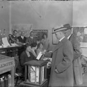 Interior view shows Governor Clarence J. Morely as he casts his vote at a polling place in Denver, Colorado. Shows a ballot box and polling officials. Governor Morely was associated with the Ku Klux Klan during his term from 1925 to 1927.