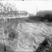 View of Cherry Creek and the 8th (Eighth) Avenue bridge in Denver, Colorado. Waves arise from flood water resulting from the breach of the Castlewood Canyon Dam.