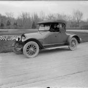 Mrs. Sade Rhoads sits in a 1918 Kissel two passenger sedan in a Denver, Colorado park.