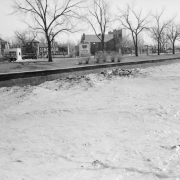 View of Cherry Creek, in Denver, Colorado, during the Castlewood Dam flood. Speer Boulevard and a Sinclair gas station edge the water.