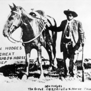 Benjamin J. Hodges, a Mexican Black man, poses with a horse, a rifle, and a pistol in a holster.