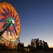 Lights glow in a time lapse photo of the Ferris Wheel as fairgoers wait beneath it for a turn on the first day of the Colorado State Fair in Publo, Colo., on Friday, August 24, 2007. The Midway is where the the rides and games are at and is popular, es...
