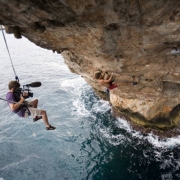 Josh Lowell filming Chris Sharma rock climbing / deep water soloing on The Arch, his project in Cala Santanyi, Mallorca, Spain. As of July 18, 2006 Sharma had not completed the free climbing route.
