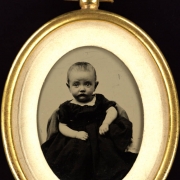 Studio portrait of a girl. She wears a dress.