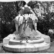 Shows the Children's Fountain located in City Park in Denver, Colorado. The marble statue and fountain was built by Max Blondet, a Prussian sculptor, in 1912. He copied the design from the original sculpture in Dusseldorf, Germany done by Henry C. Charpeot.