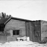 View of the garages and tool shed at the Willis Case Municipal Golf Course (formerly Rocky Mountain Golf Course) in Denver, Colorado. Round and rectangular planters are near the buildings.