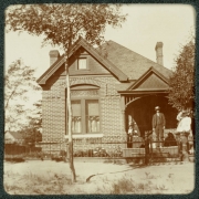 A family poses on the porch of their brick home in Denver, Colorado.