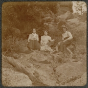 A family poses on a hillside in the mountains of Colorado.