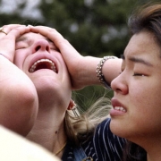 Grief overcomes two Columbine students moments after fleeing a violent rampage.