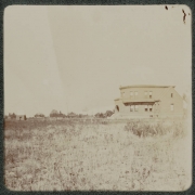View of a building in Denver, Colorado. The semi-circular building has an arched entryway.