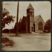 View of a church in Denver, Colorado. The building has arched windows and a tower topped with a belfry.