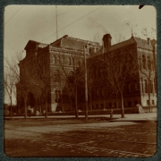 View of East Denver High School (East High) on 19th (Nineteenth) and Stout Streets in Denver, Colorado. A man walks near the entrance.