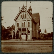 View of Fire Station Number 1 (One) on the corner of Colfax Avenue and Broadway in Denver, Colorado. A sign on the building reads: "Engine Co. No. 1". The steeple of the Central Presbyterian Church is in the distance.