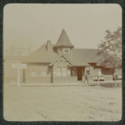 A man walks near a tramway station probably in Denver, Colorado.