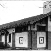View of the bathhouse in Elyria Park at 48th (Forty-eighth) Avenue and High Street in Denver, Colorado. The building has a tile roof and decorative brick accents.