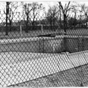 View of a drained swimming pool in Elyria Park at 48th (Forty-eighth) Avenue and High Street in Denver, Colorado.