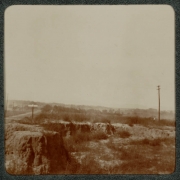 View of a canyon and dirt road possibly near Denver, Colorado. Powerlines and poles cross the canyon.