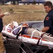 Rescue workers wheel a wounded student toward an ambulance.