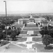 A view of Civic Center Park in Denver, Colorado. Shows the City and County Building, the Denver Public Library, the Voorhies Memorial and the Greek Amphitheater. The Denver skyline and the foothills are in the background.