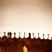 Fifteen crosses honoring the Columbine dead stand in the night glow.