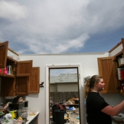 ({seqn)} Allison Larson looks in her kitchen cabinet while meeting with insurance agents at her home on Sunday, May 25, 2008. The Larsons' house was destroyed in the tournado that hit Windsor, Colo., last week.  (PRESTON GANNAWAY/ROCKY MOUNTAIN NEWS)  ...