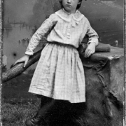 Studio portrait of (possibly) Augusta Louise Tabor, in a dress and high button shoes.