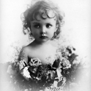 Studio portrait of Elizabeth Bonduel Lillie Tabor (daughter of Horace and Baby Doe Tabor), with cut flowers.