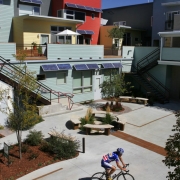 Rresident Paul Mack (Cq) returns home after a bike ride to his solar condo complex by architect Michael Tavel (cq), in the Prospect community in Longmont, Co. on Sept. 19, 2006.  Tavel won the architects' choice award.  Above the windows are solar pane...