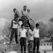 Boys stand on a jungle gym during the dedication of the George Washington Carver Day Nursery at 2260 Humboldt Street in the City Park West neighborhood of Denver, Colorado.