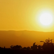 Mountain bikers with bikes in tow camp near the Bookcliffs area as the sun sets after riding at the 11th Annual Fruita Fat Tire Festival on Friday April 28, 2006. The Festival went back to its roots this year featuring loosely organized rides many host...