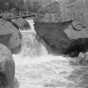 View of a wooden bridge over a waterfall at South Boulder Creek, Eldorado Springs (Boulder County), Colorado.