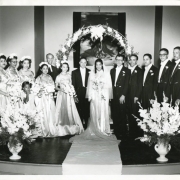 Photograph of the Kinchelow Gash wedding at People's Presbyterian Church in Denver, Colorado.  Pictured in photograph from left to right are: Bridesmaides Barbara Cannon, Marion Adams, Jane Matlock King, Maid of Honor Virigina Gash,  Flower Girl Anita Quick, Reverend Hugh Mullings, Groom Lee Gash, Bride Thelma Kinchelow, Best Man Albert Miller, Groomsmen Richard ""Dickie"" King, Eugene Carter, Raymond Davis, Cannon Kinchelow.