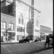 View of the (William Fox) Rivoli Theater at 1751 Curtis Street in  Denver, Colorado; sign advertises the film "Passion", starring "Pola Negri  & cast of 5,000." Landmarks include Original Frisco Restaurant, Cosmos Hotel, Chas. Bomash Loan Office, and Paris Restaurant.