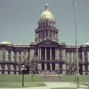 View of the State Capitol building in Denver, Colorado. Men and women walk on the steps in front of the building.