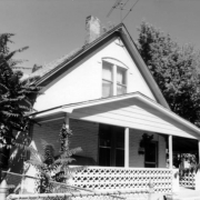 View of a house at 2655 Stout Street in the Five Points (Curtis Park) neighborhood of Denver, Colorado. The two-story house has a covered porch with a decorative wall.