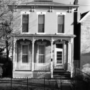 View of a house at 2752 Champa Street in the Five Points neighborhood of Denver, Colorado. The two-story house has a covered porch.