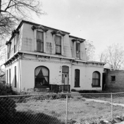 View of a house at 2445 California Street in the Five Points neighborhood of Denver, Colorado. The two-story house has decorative eaves.