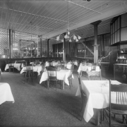 Interior view of the Daniels and Fisher store in Denver, Colorado; shows the dining room, tables, and wooden screens.