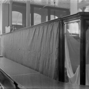 Interior view of the Daniels and Fisher store, in Denver, Colorado; shows glass display cases and a protective curtain.
